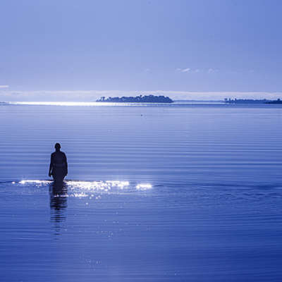 Woman Walking Into a Lake